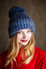 Portrait of playful woman in knitted winter cap