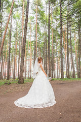 Gorgeous  Blonde bride with bouquet outdoor, posing