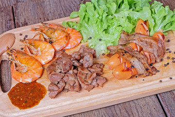 Grilled meat and shrimps with vegetables, barbecue grill food on