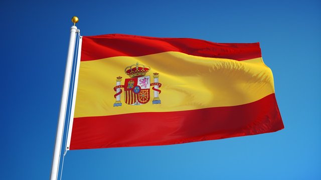 Spain flag waving in slow motion against clean blue sky, seamlessly looped, close up, isolated on alpha channel with black and white luminance matte, perfect for film, news, digital composition