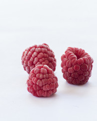 frozen raspberries isolated on white