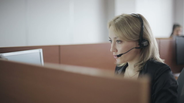 Attractive woman customer support phone operator at workplace