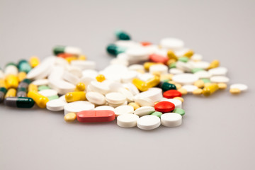 Composition with colorful pills and light grey background