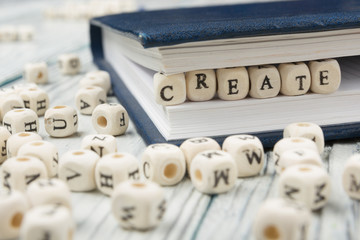 text of CREATE on wood cubes. Wooden abc