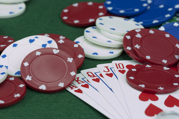 Poker chips and cards on a green table