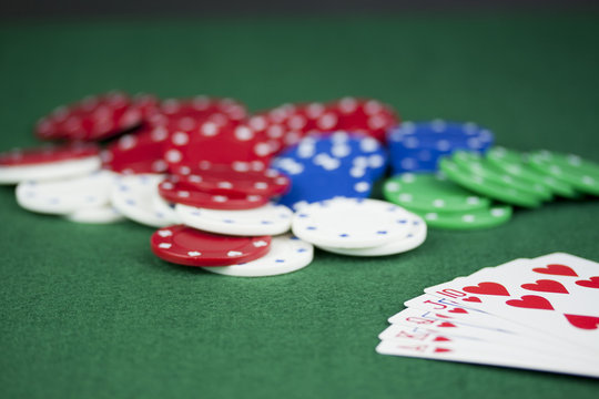 Poker chips and cards on a green table