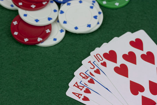 Poker chips and cards on a green table