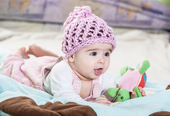 Beautiful newborn baby girl in pink hat.