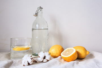 Tasty cool beverage with lemon on white cotton fabric