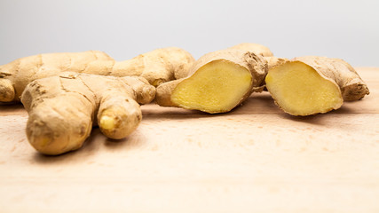 Ginger pieces on wooden kitchen board