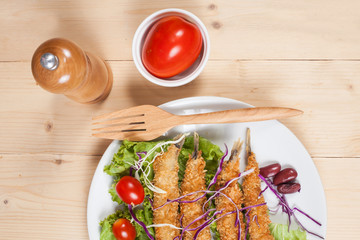 Fish fry in plate on wood desk