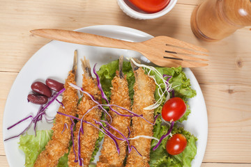 Fish fry in plate on wood desk