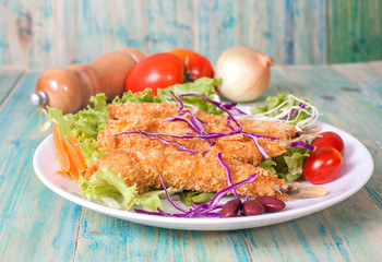 Fish fry in plate on wood desk