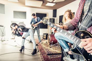 Rock band performing in recording studio