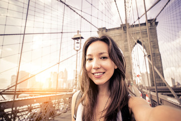 Woman taking selfie on Brooklyn Bridge
