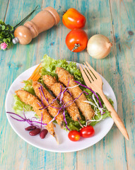 Fish fry in plate on wood desk