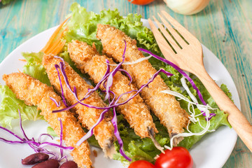 Fish fry in plate on wood desk
