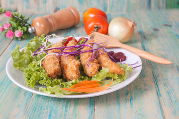 Fish fry in plate on wood desk