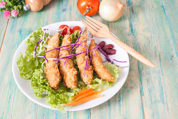Fish fry in plate on wood desk