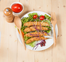 Fish fry in plate on wood desk