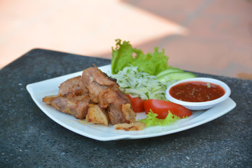 Grilled pork shashlik with salad on the plate