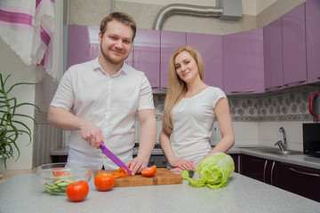 man and woman in the kitchen preparing
