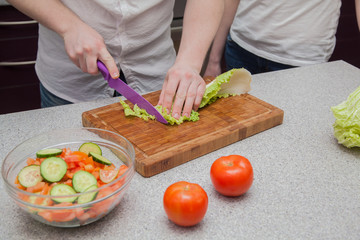 man and woman in the kitchen preparing