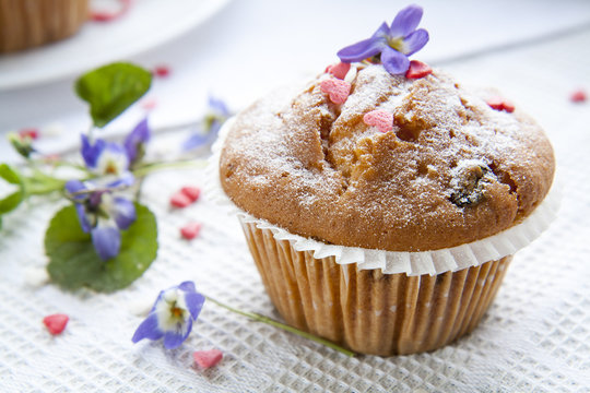 Tasty muffins with sugar hearts and cup of green tea