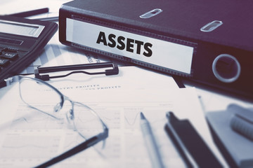 Assets - Office Folder on Background of Working Table with Stationery, Glasses, Reports. Business...