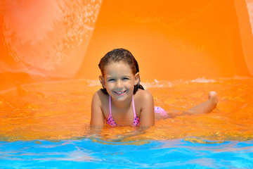 Adorable toddler girl enjoying her summer vacation at aquapark