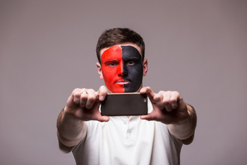Albanian football fan take selfie photo with phone on grey background. European 2016 football fans concept.