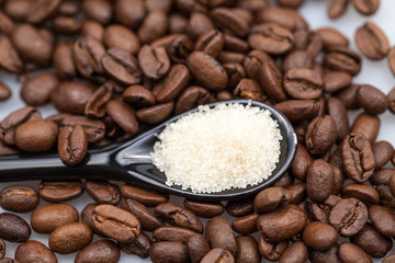 Coffee beans, brown sugar and small teaspoons