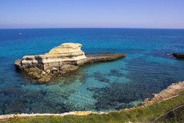 Fototapeta na wymiar Rocky stacks on the coast of Salento in Italy