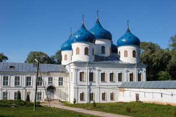 Fototapeta na wymiar St. George's monastery in Veliky Novgorod. The Orthodox Christian Church. The Orthodox religion of Russia. The monastery's oldest Church buildings in Russia in 1030 year. White Church with blue domes.