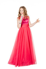 Obraz na płótnie Canvas Studio shot beautiful young singing girl in elegant red dress 