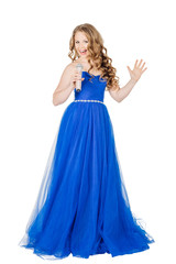 Fototapeta premium Studio shot beautiful young singing girl in elegant blue dress l