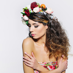 Beauty portrait of a gorgeous woman with gipsy hairstyle wearing handmade fairy flower crown