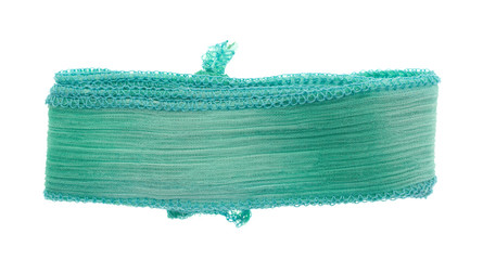 Fototapeta premium Green ribbon cloth material on a white background