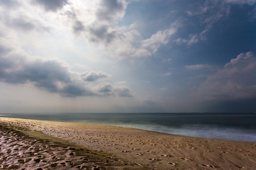 Night beach by the ocean, long exposure. Sky with clouds coverin