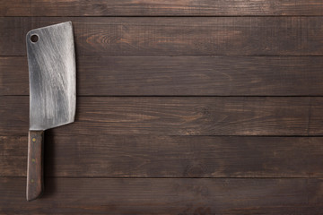 Cleaver on the wooden background for you text.