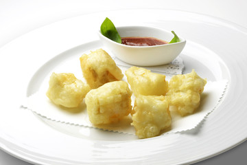 Fried pieces of codfish with tomato sauce
