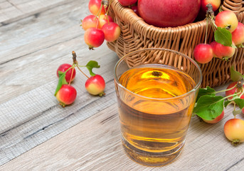glass of apple juice and a basket of apples