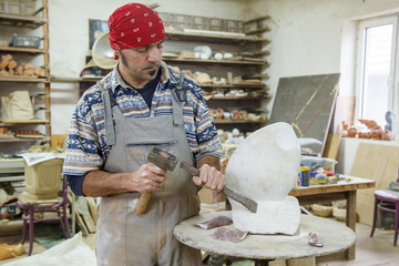 Sculptor carves marble
