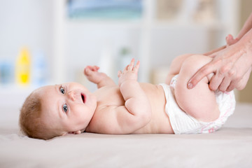 mother massaging or doing gymnastics to baby