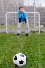 little soccer goalkeeper saving the goal