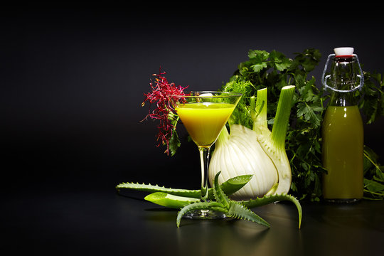 Fresh vegetable juices on black table