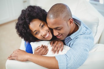 Fototapeta premium Portrait of smiling couple on the sofa