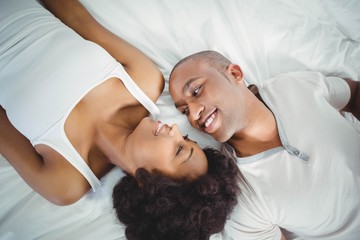 Obraz na płótnie Canvas Happy couple lying on the bed