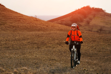 Fototapeta premium Man cyclist with backpack riding the bicycle