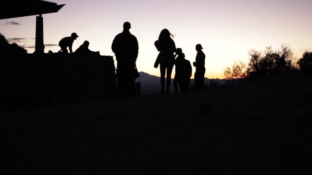 Tourists enjoy the sunset at a mountain park